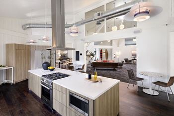 a kitchen with a large island and a living room